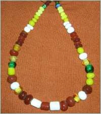 Glasperlen Kette, zwei kleine grüne,  viele (15) rote und etwas weniger gelbe und rote Perlen